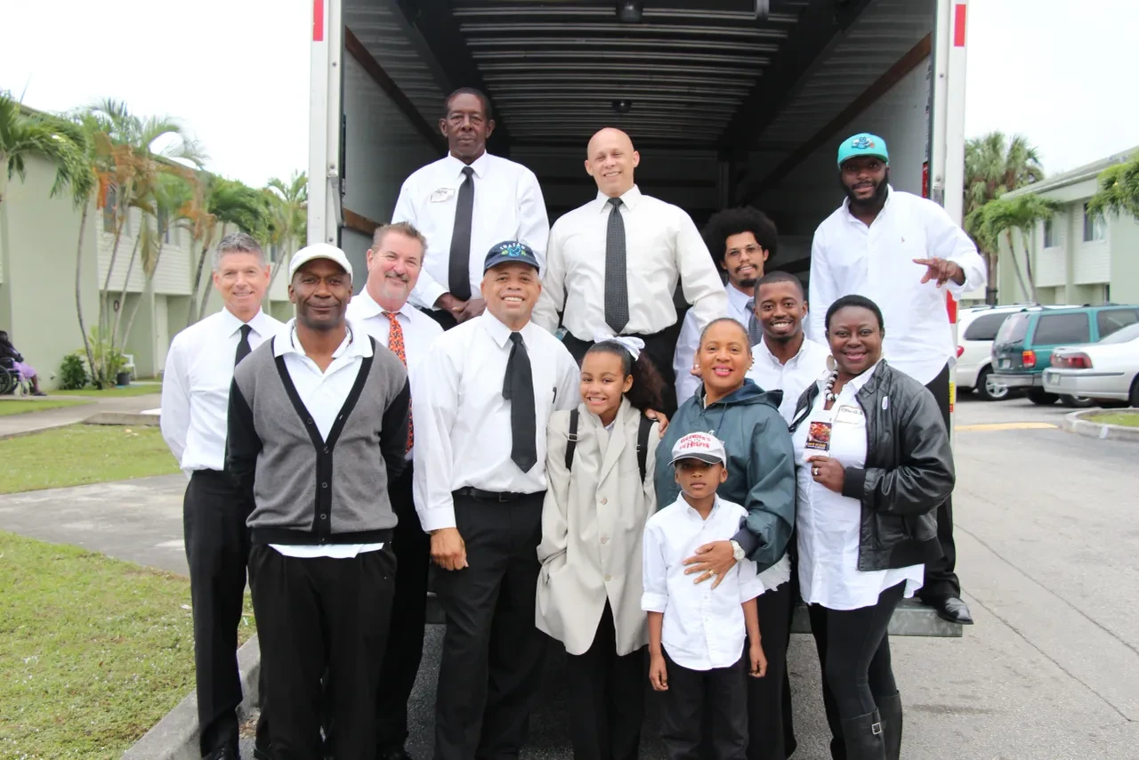 Volunteer team group photo in front of U-Haul truck at 2014 community event
