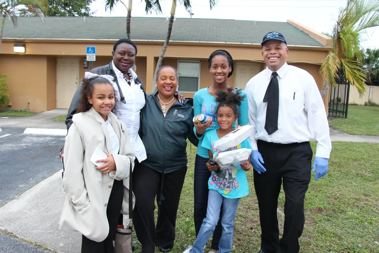 Group of volunteers and community members posing outside after distribution