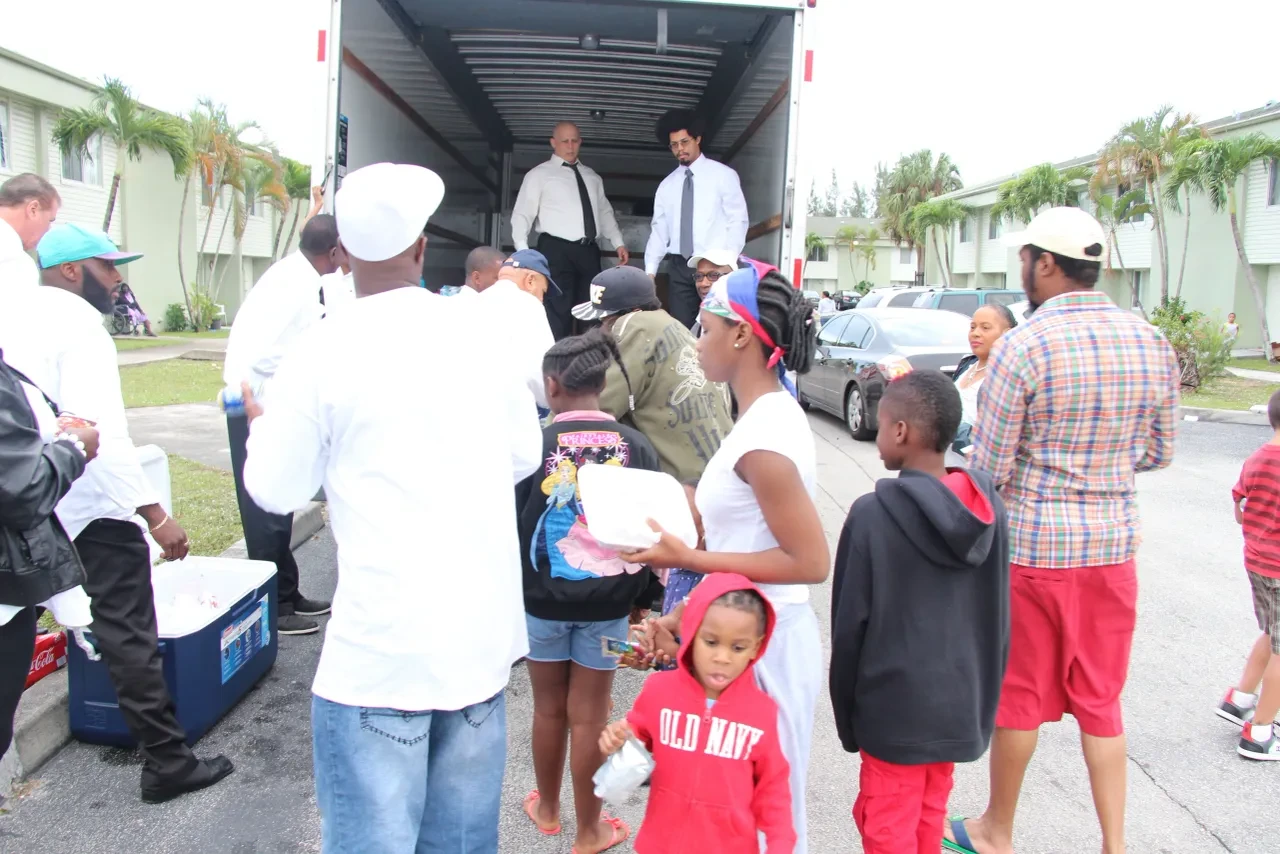 Community members receiving food from volunteers at U-Haul truck