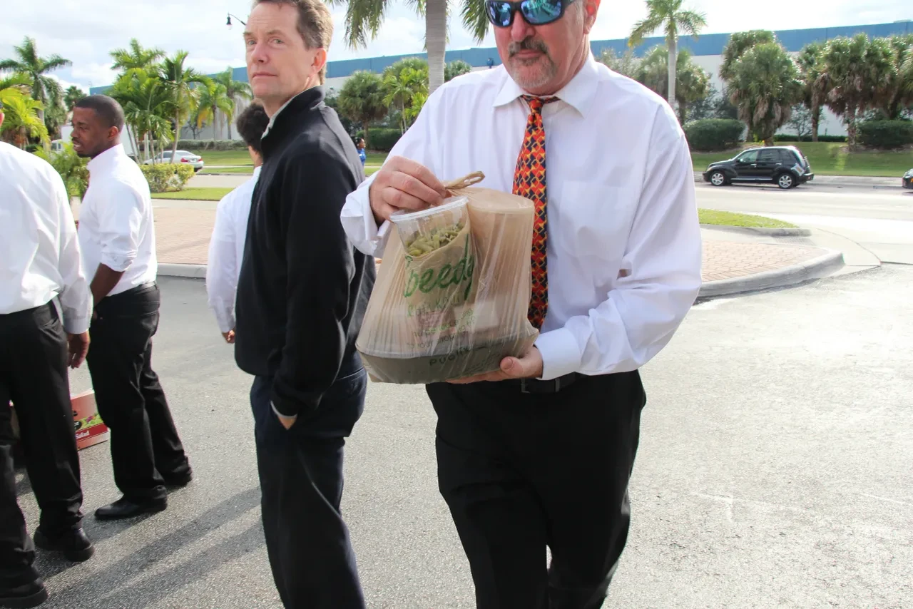 Volunteer carrying food bag at outdoor community event