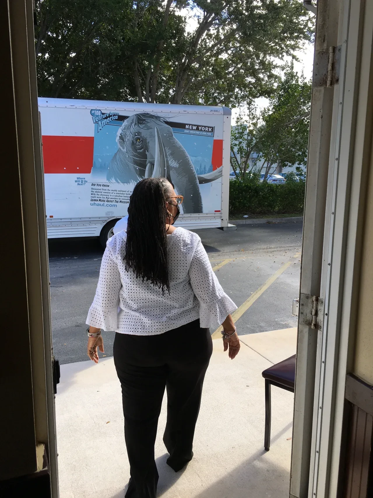 Volunteer looking out doorway toward U-Haul truck