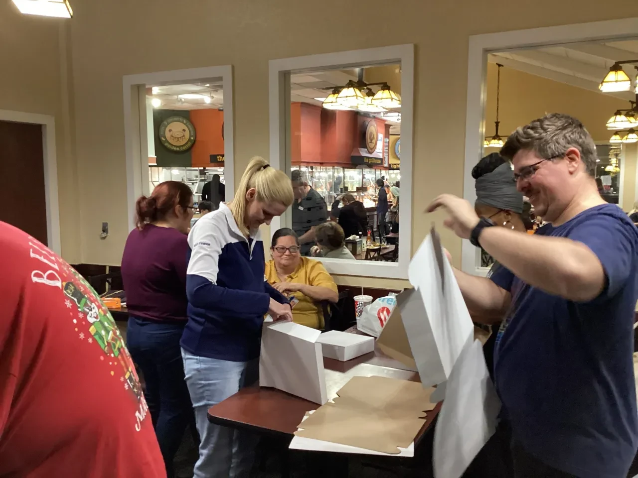 Volunteers assembling food boxes at Golden Corral restaurant event