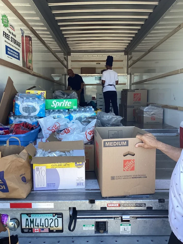 Inside U-Haul truck packed with water, Sprite, food boxes and supplies