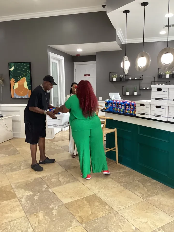 Volunteer handing out juice boxes at distribution counter