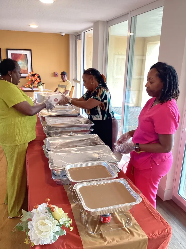 Volunteers setting up chafing dishes for holiday meal service