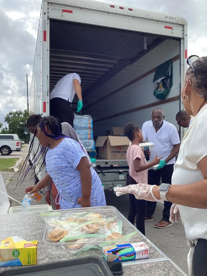 Community members unloading supplies from truck