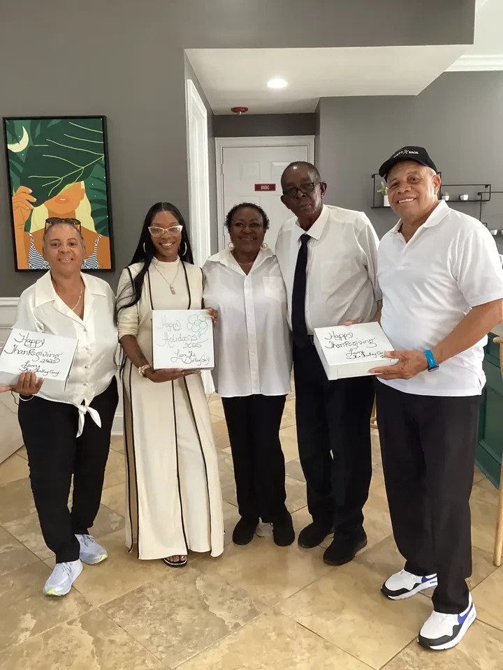 Group holding Happy Thanksgiving boxes indoors