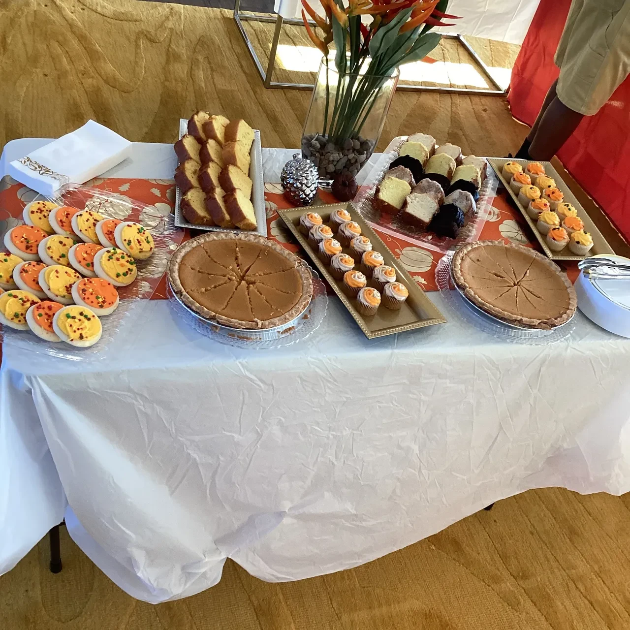 Holiday dessert table with pies, cupcakes, and cookies