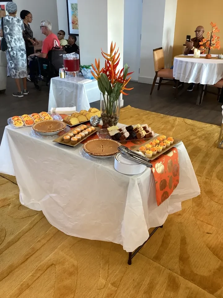 Indoor event dessert table with fall floral arrangement