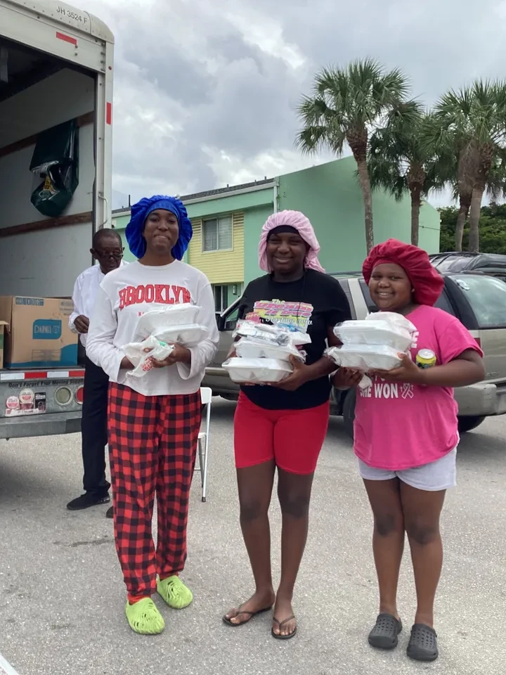 People distributing food donations at community event