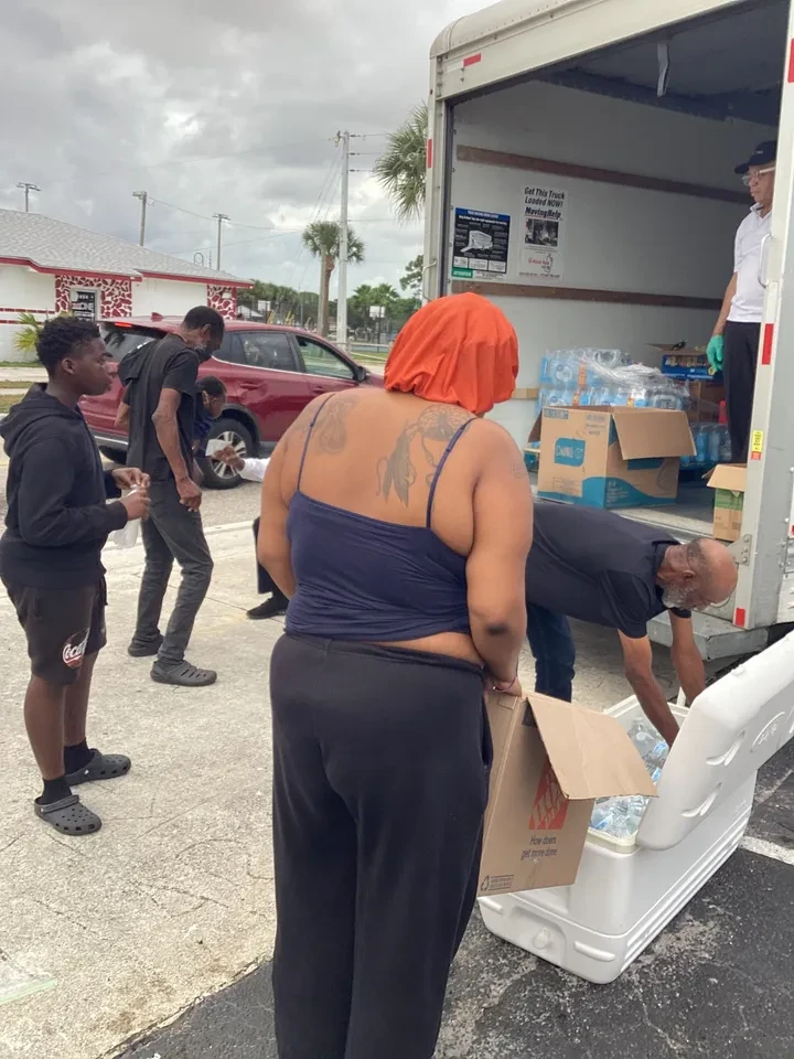 Volunteers unloading water and supplies from truck