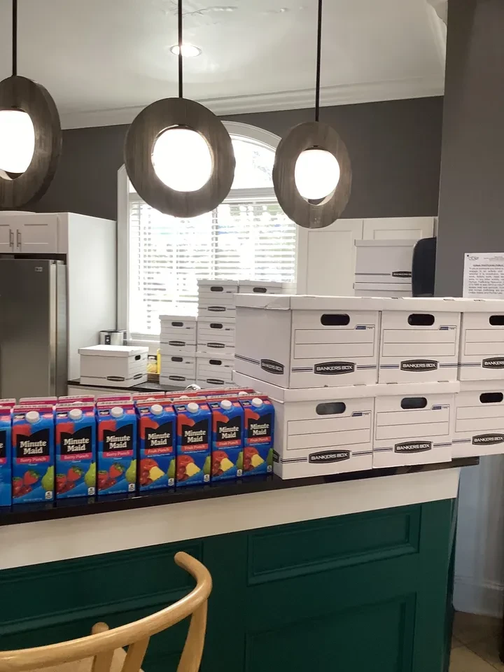 Juice boxes and bankers boxes staged at distribution counter