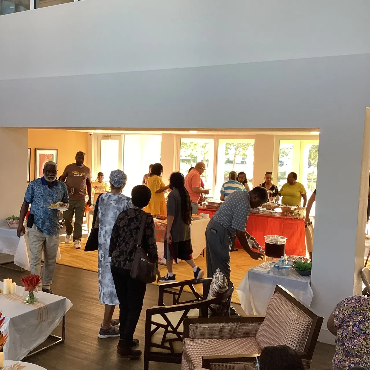 Community members gathering at indoor holiday meal event