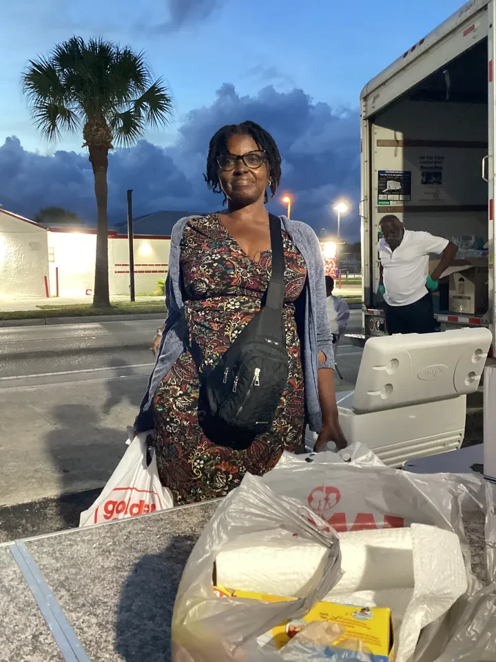 Volunteer at night distribution event by truck