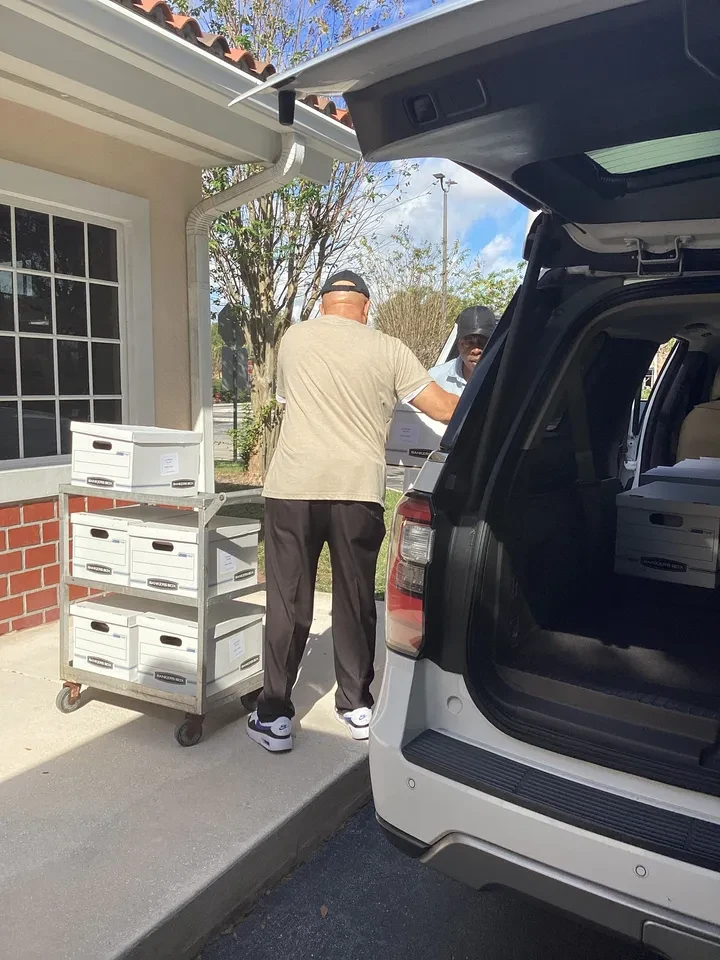 Volunteers loading boxes into vehicle