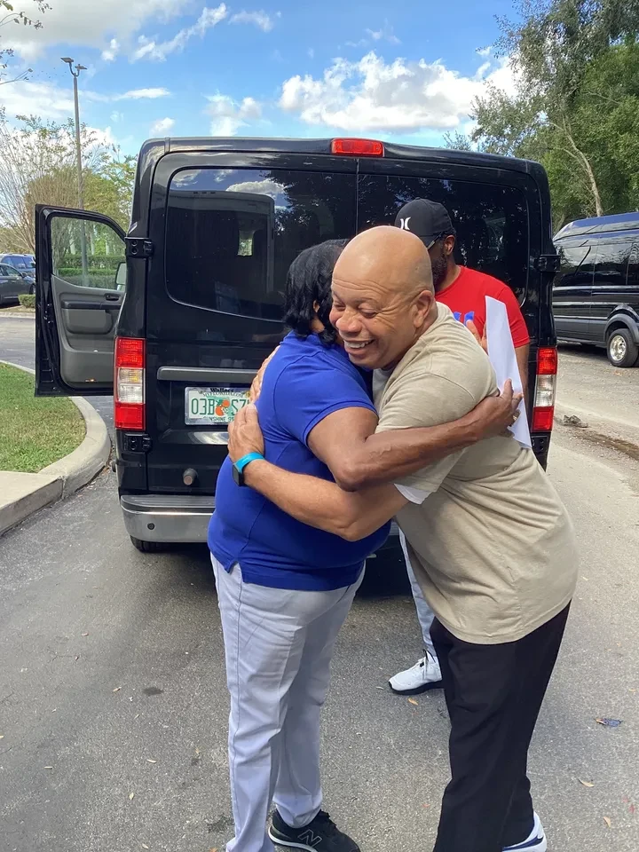 Community members embracing at outreach event