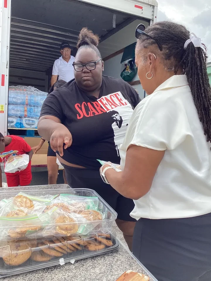 Volunteers distributing baked goods at food truck