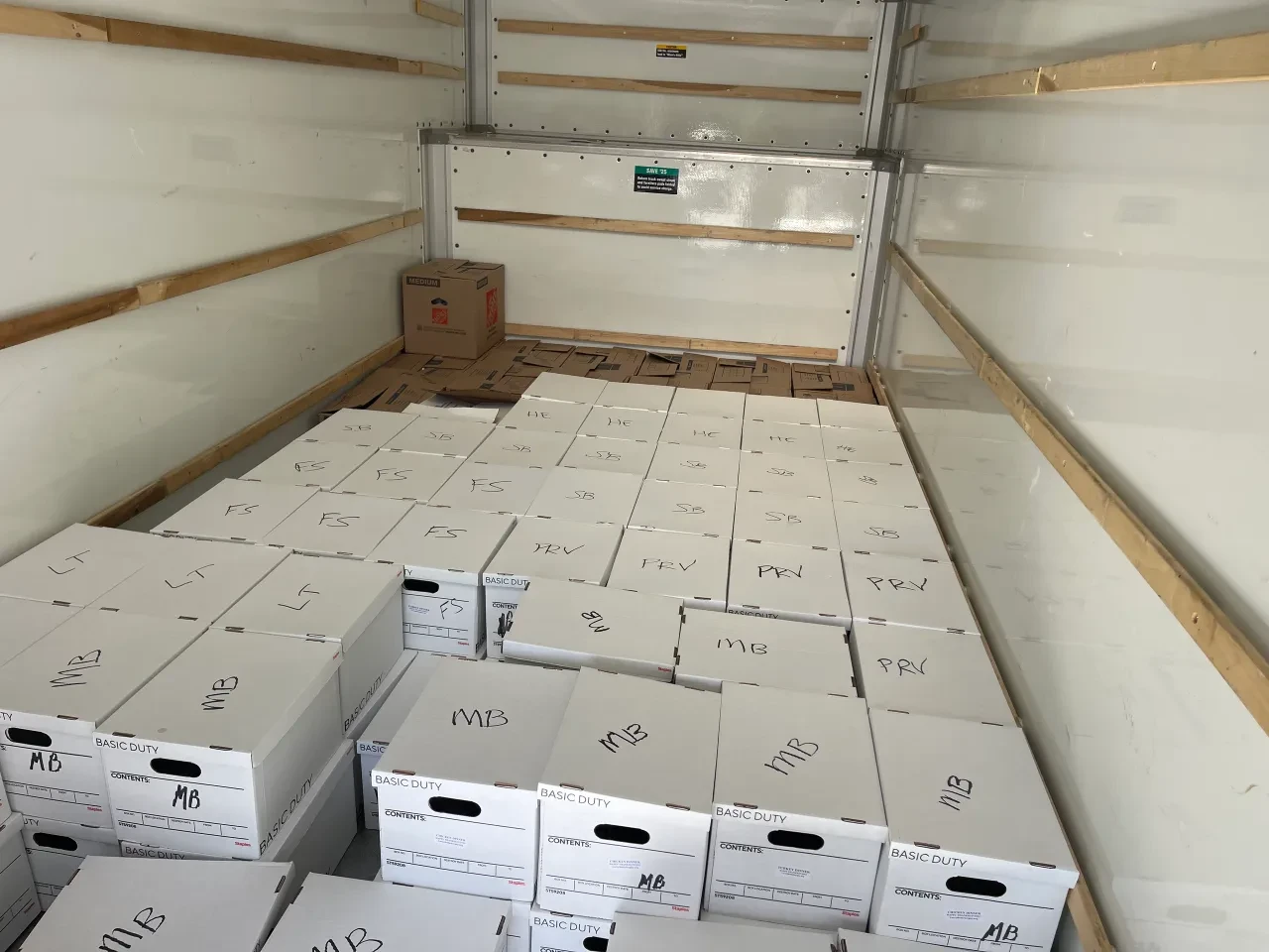 Truck loaded with labeled banker boxes ready for distribution